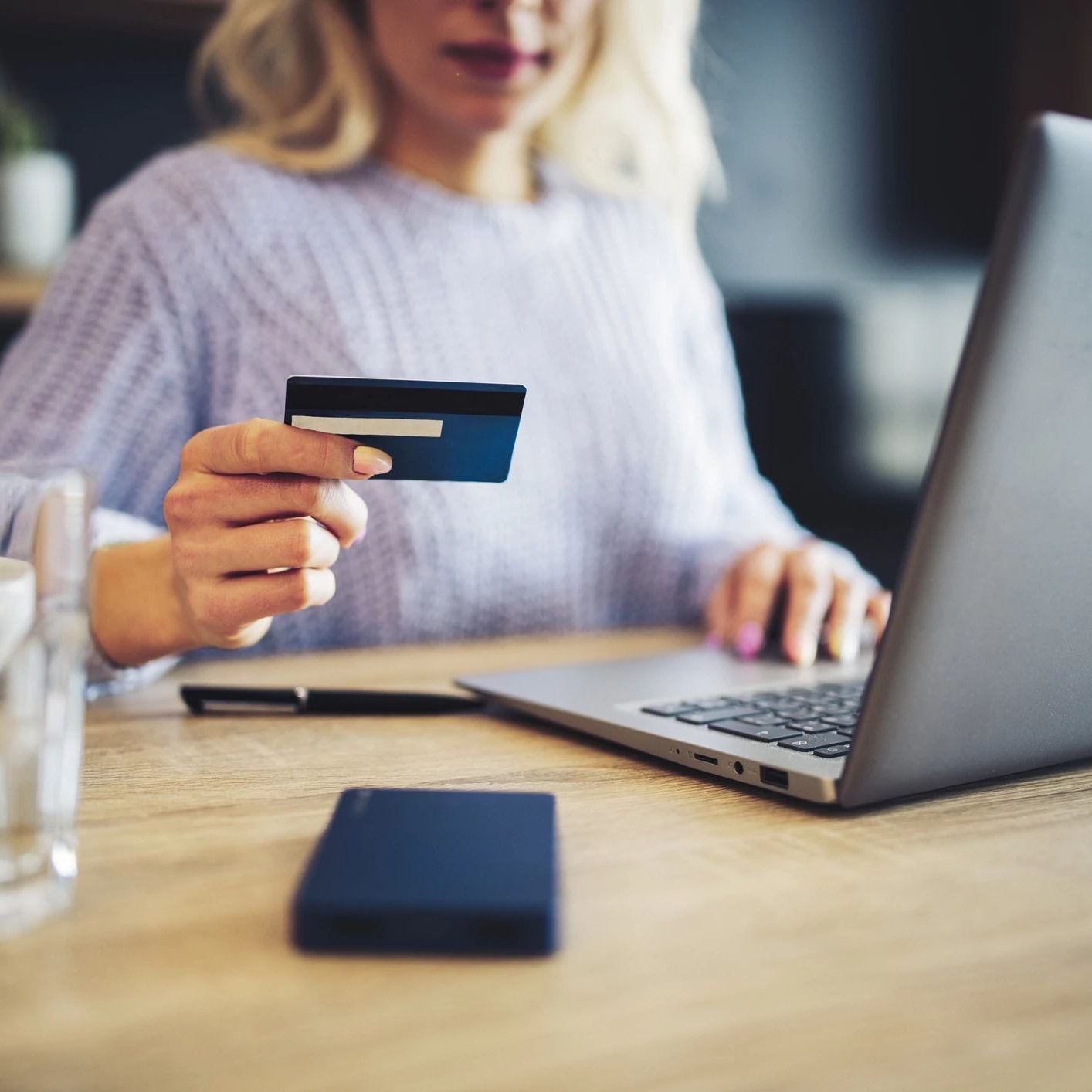 Person paying by card online with a laptop - Matson Rugs, Inc in Berlin, CT